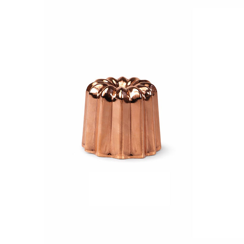 Copper canele mold on a white background