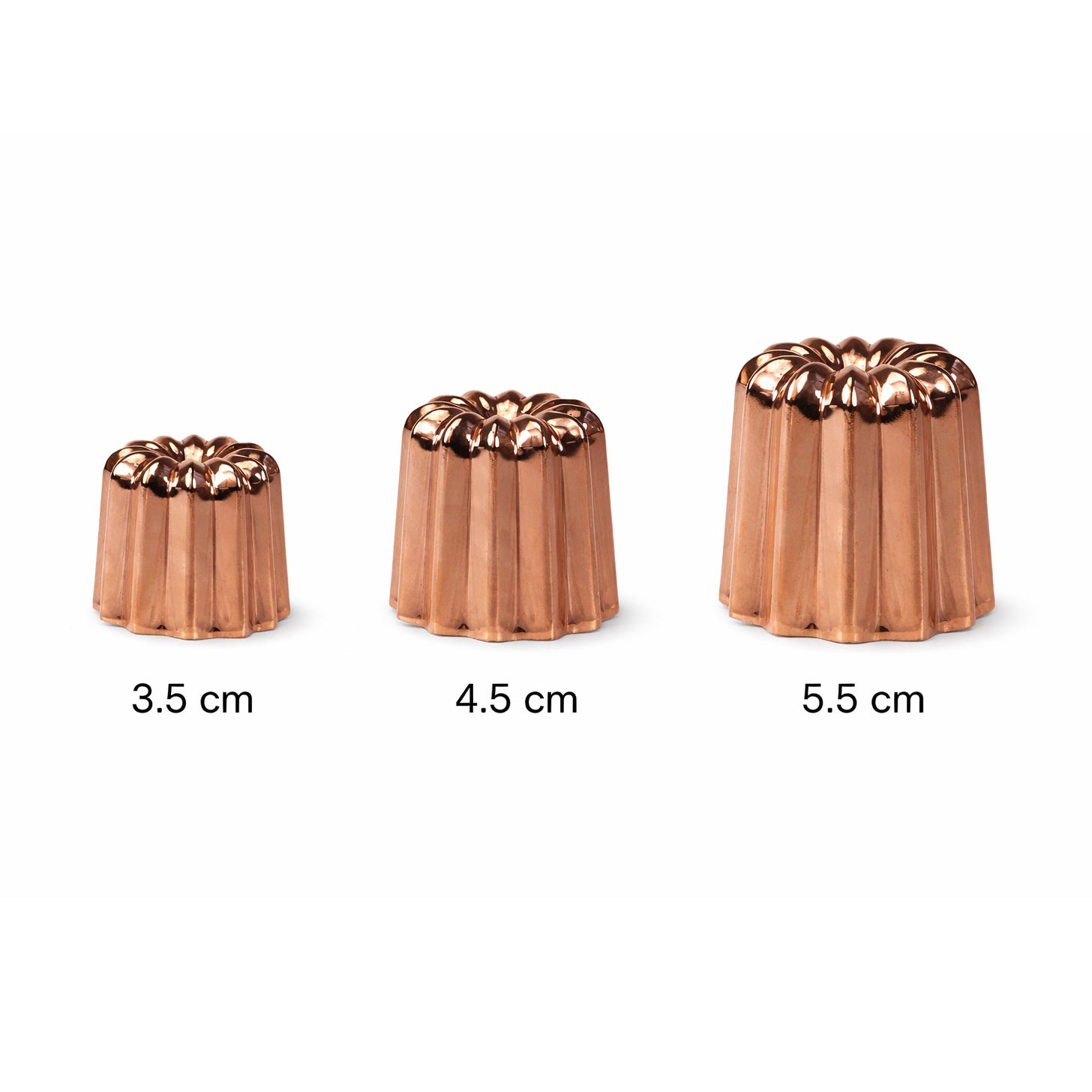 Three copper canele molds of different sizes on a white background