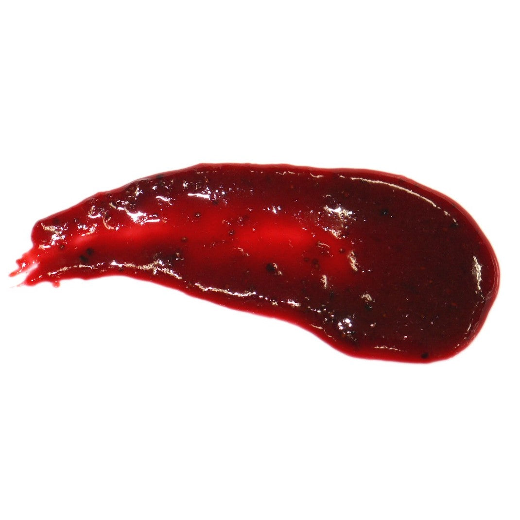 A glossy, dark red purée or gel-like strawberry flavouring paste swirled into an irregular smear on a plain white background.