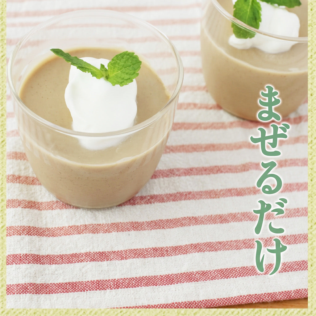 Two clear cups filled with a light brown dessert or pudding made with Namisato White Sesame Paste, each topped with a white dollop and a small green mint leaf, set on a red-and-white striped cloth. Japanese text appears vertically on the right side.
