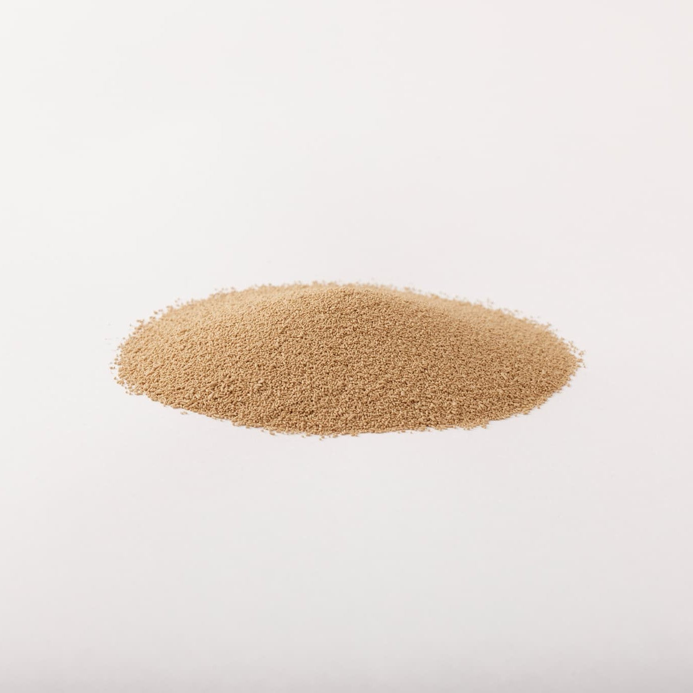 Pile of Hokkaido dry yeast on a light gray background