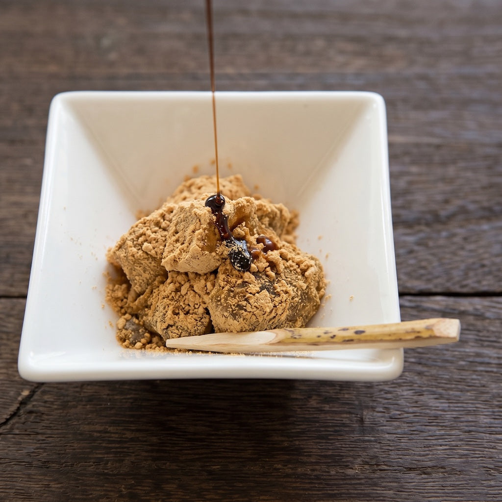 Okinawa black sugar syrup drizzle on a bowl of black sugar warabi mochi