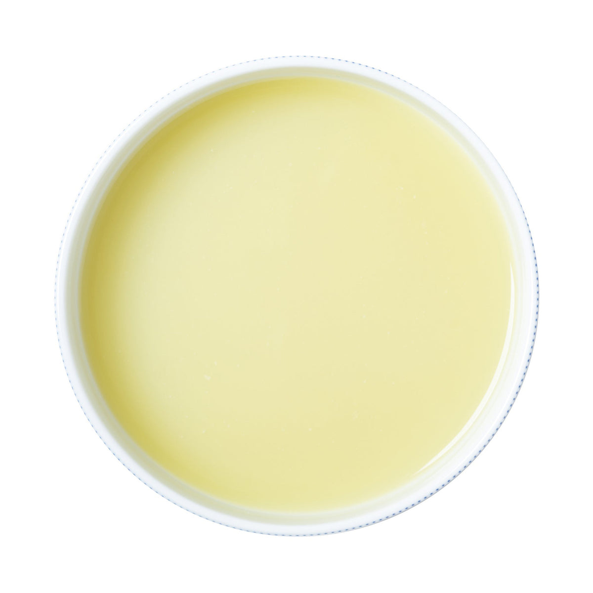White bowl filled with a light yellow lime puree on a white background