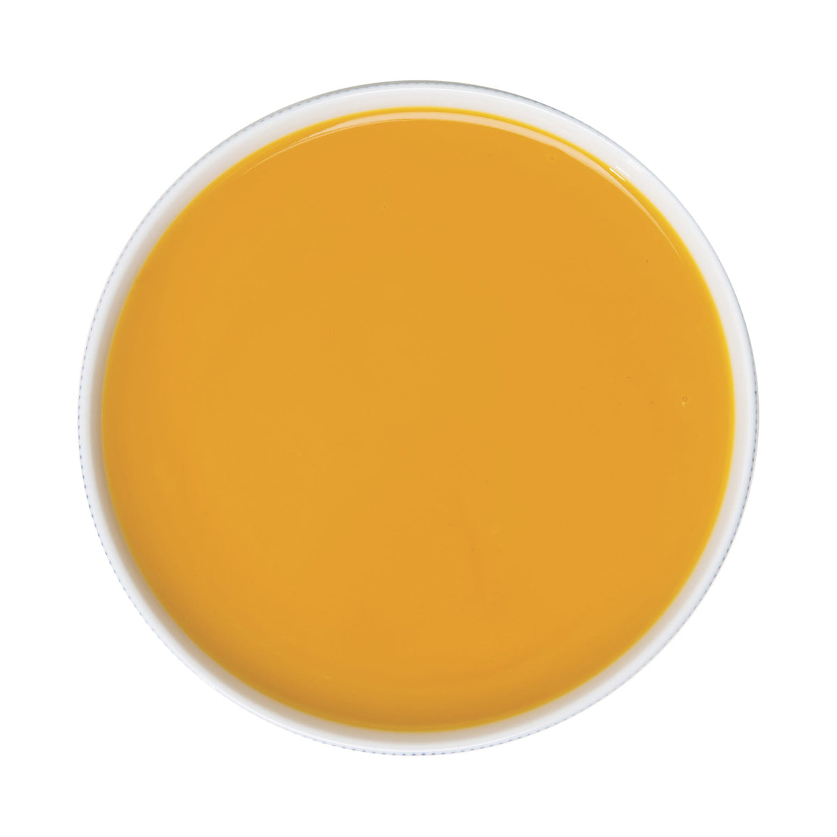 Round container of passion fruit puree on a white background