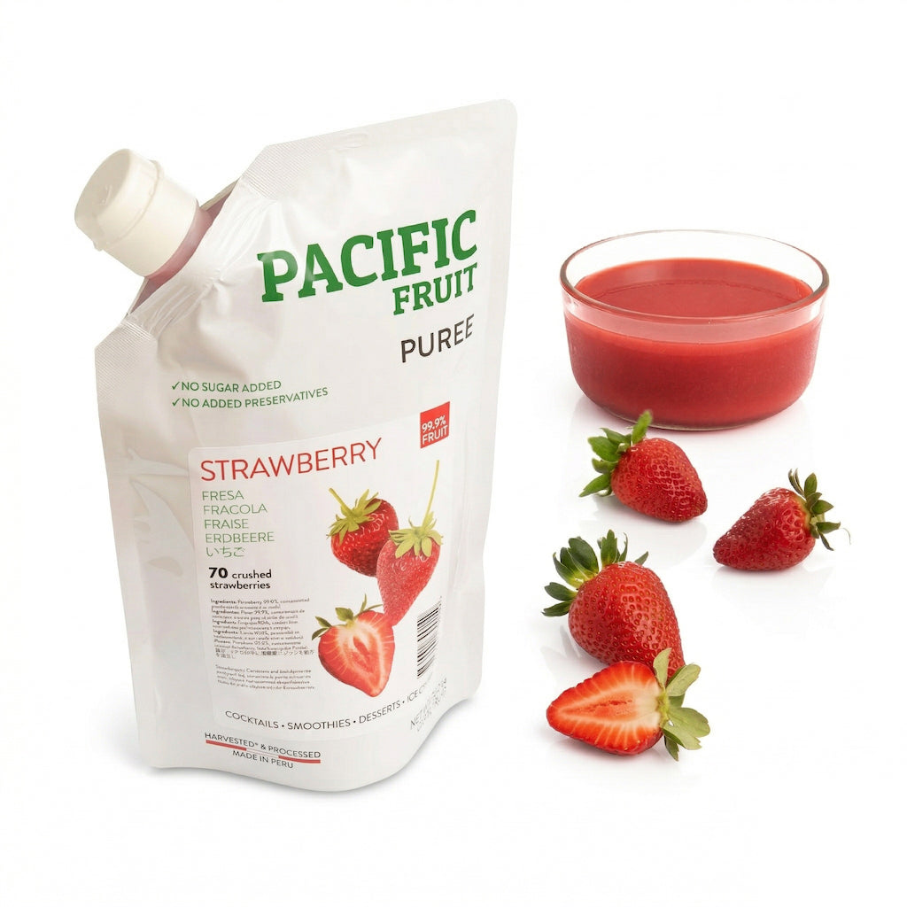 Pacific Fruit Puree strawberry pouch with a glass of strawberry puree and strawberries on a white background