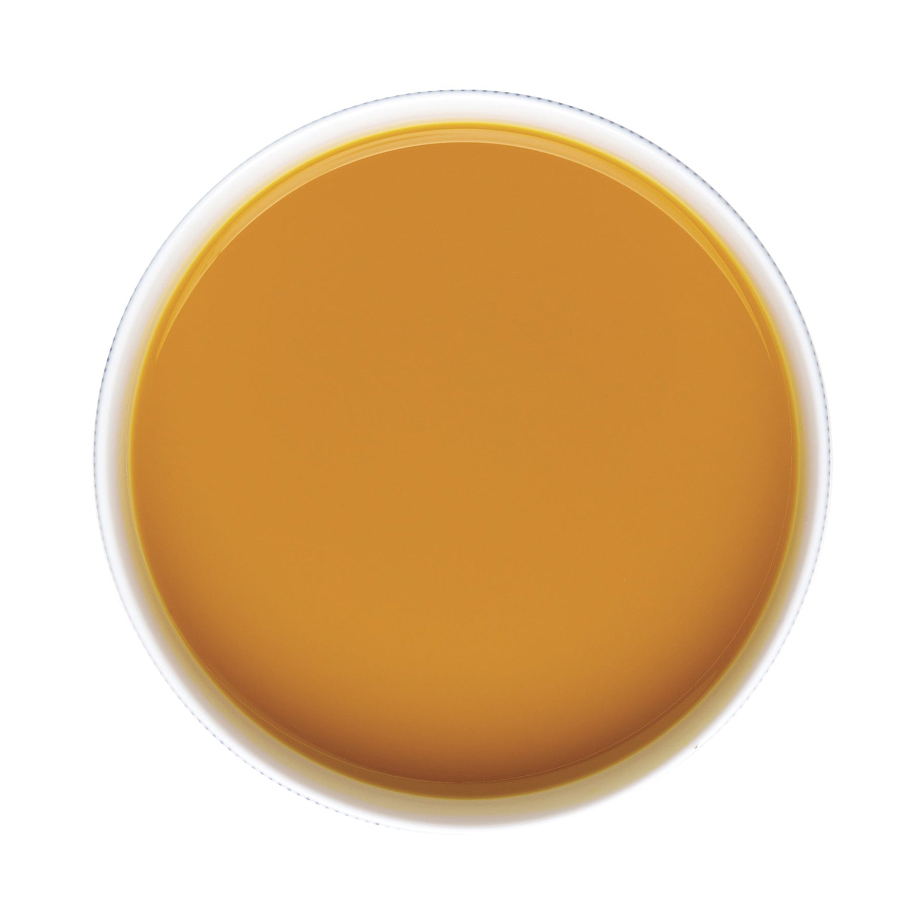 Top-down view of a white cup filled with a Pacific Fruit turmeric puree juice on a white background