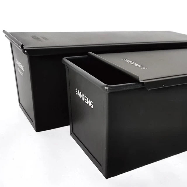 Two black Sanneng loaf pans with 'SANNENG' branding on a white background