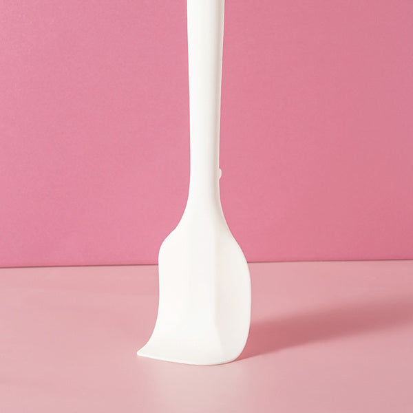 Sanneng white heat-resistant silicone spatula on a pink background