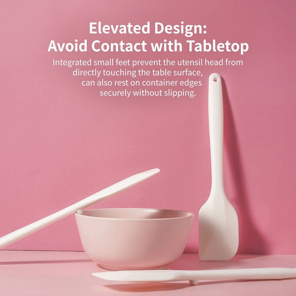 Sanneng white heat-resistant silicone spatula on a pink surface with text explaining their elevated design.