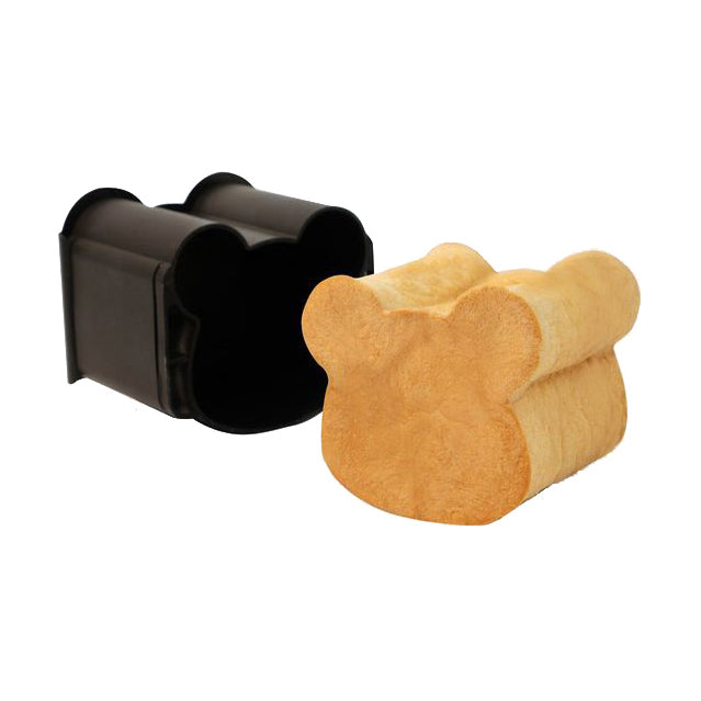 A black Sanneng bread shokupan mold shown next to a baked loaf shaped like a bear, on a plain white background.