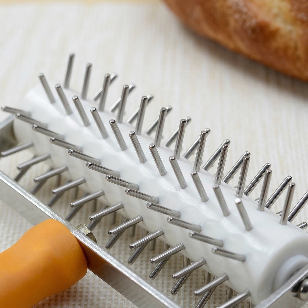Close-up of a Sanneng roller docker with a piece of bread in the background