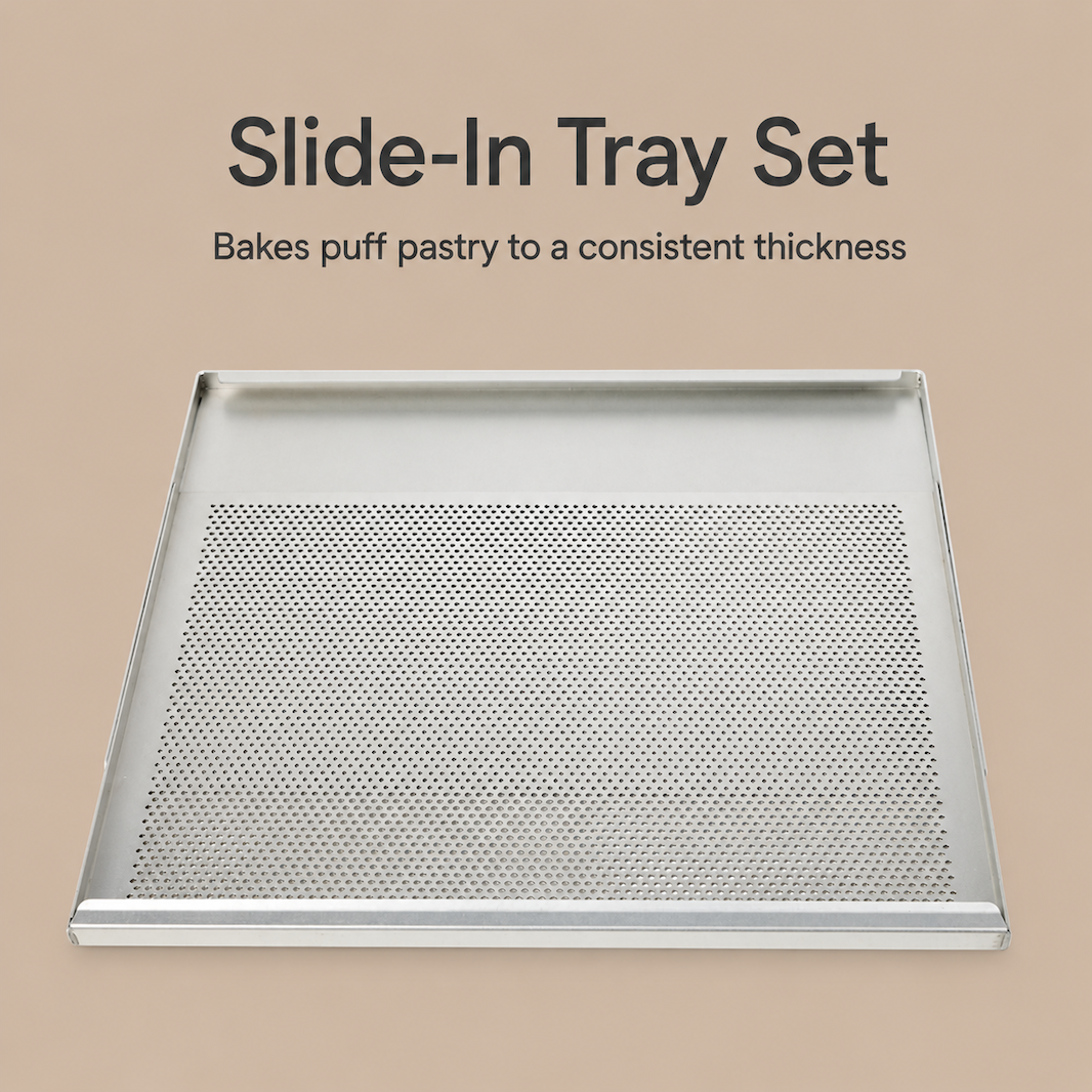 A rectangular metal slide-in tray with a perforated center panel, shown on a warm beige background with the text 'Slide-In Tray Set' and 'Bakes puff pastry to a consistent thickness.'.