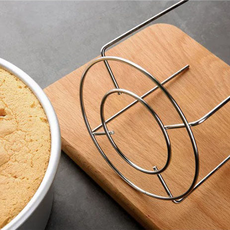 Sanneng cake cooling stand on a wooden cutting board with a cake in the background