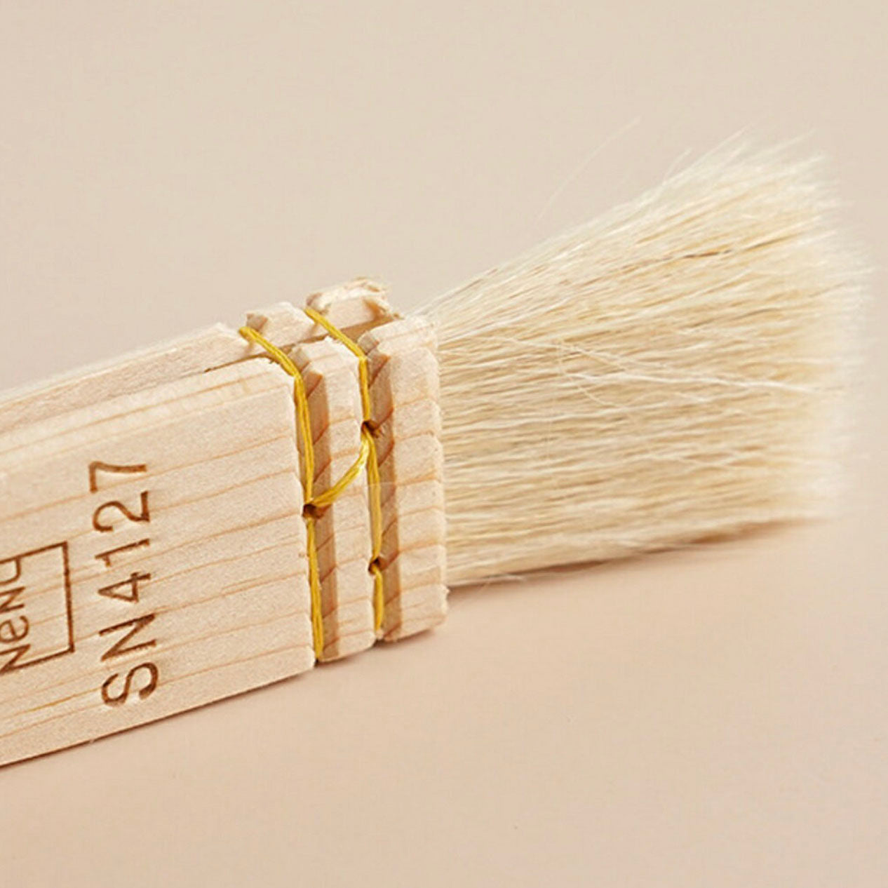 Wooden Sanneng brush SN4127 with bristles on a beige background