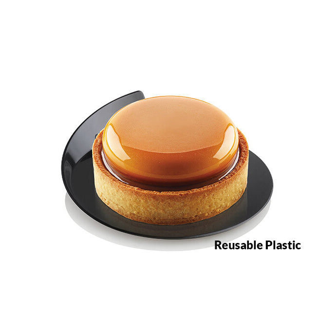 Caramel tart on a black plate with 'Reusable Plastic' text