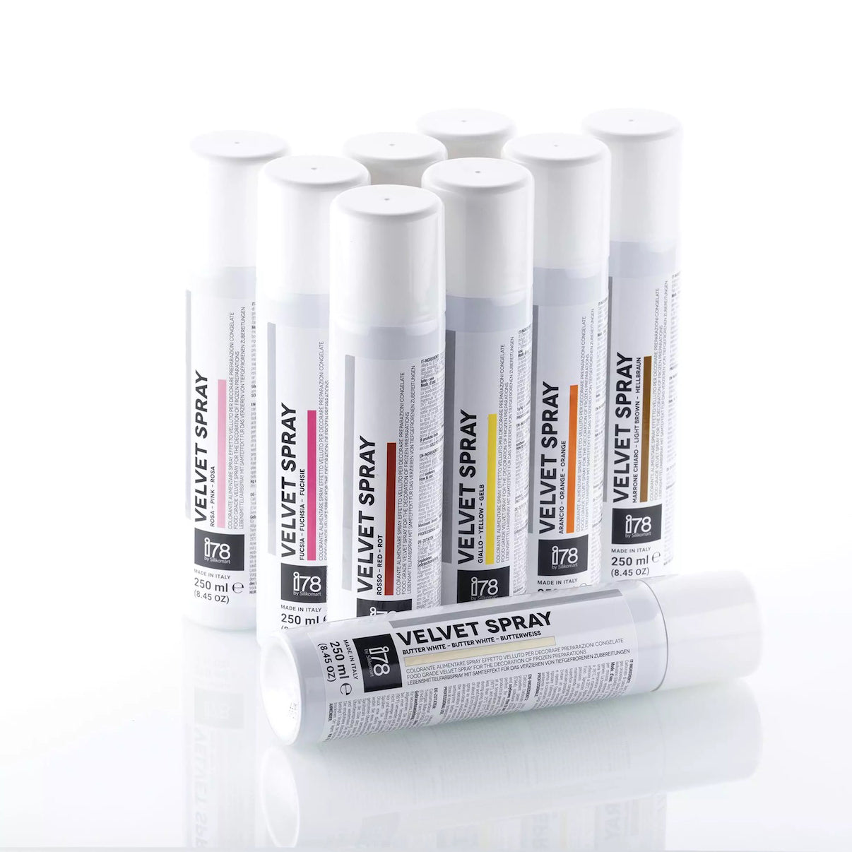 Multiple tubes of 'Silikomart Velvet Spray' on a white background