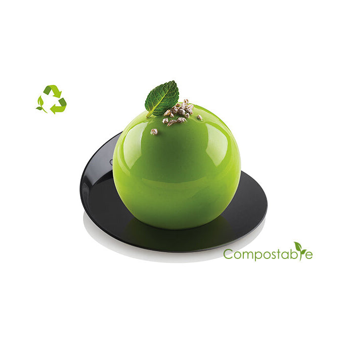 Green dessert on a black plate with 'Compostable' label and recycling symbol.