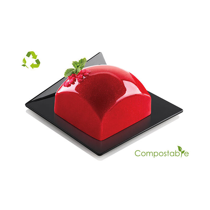 Red dessert on a black plate with 'Compostable' label and recycling symbol.