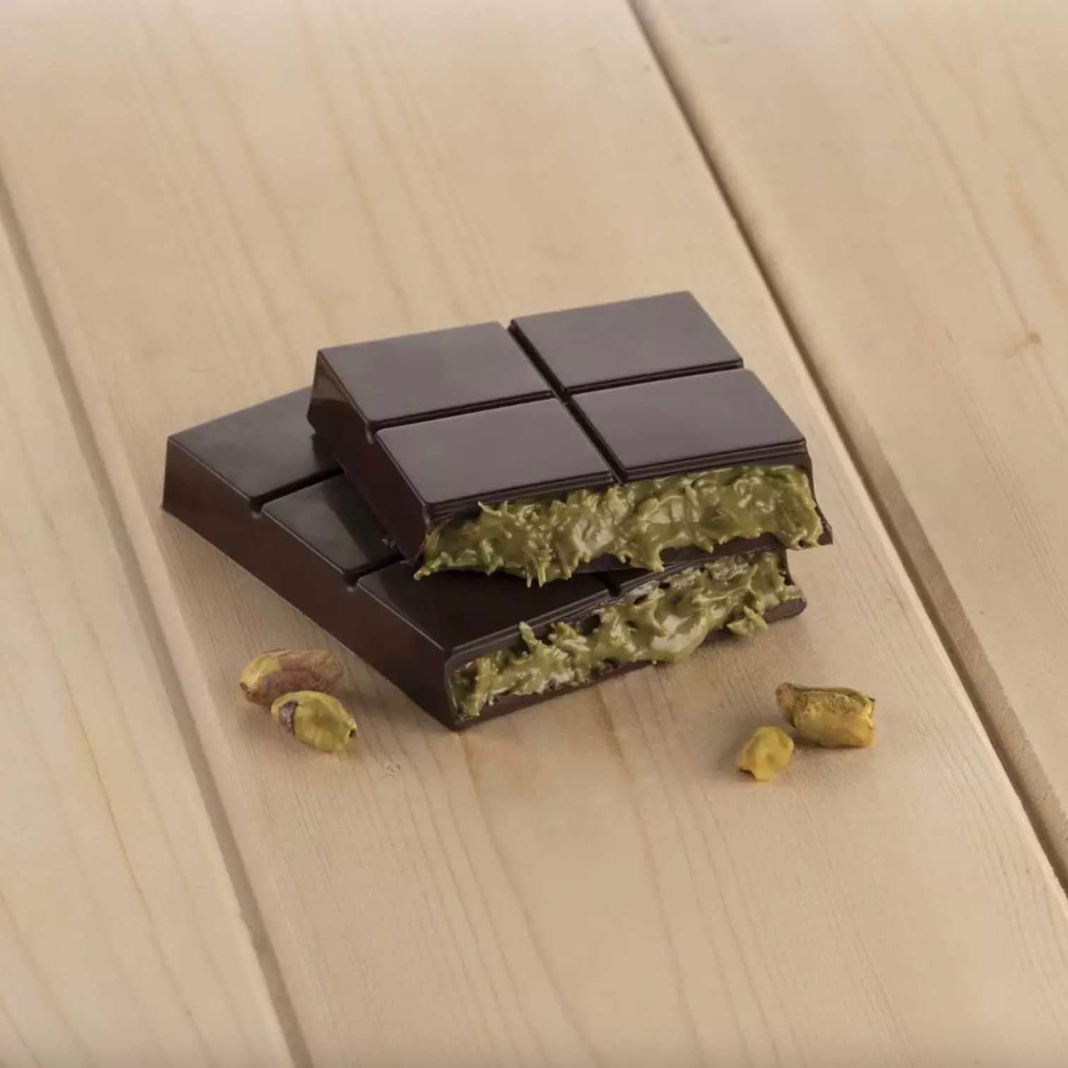 Chocolate bar with its filling on a wooden surface