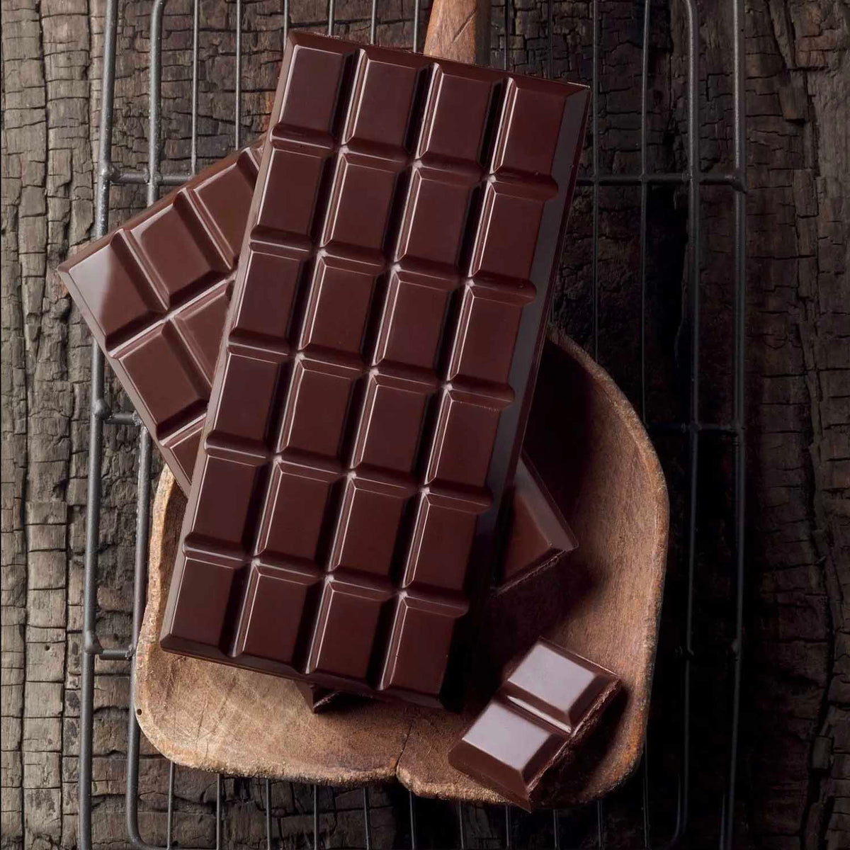Dark chocolate bar on a rustic wooden surface