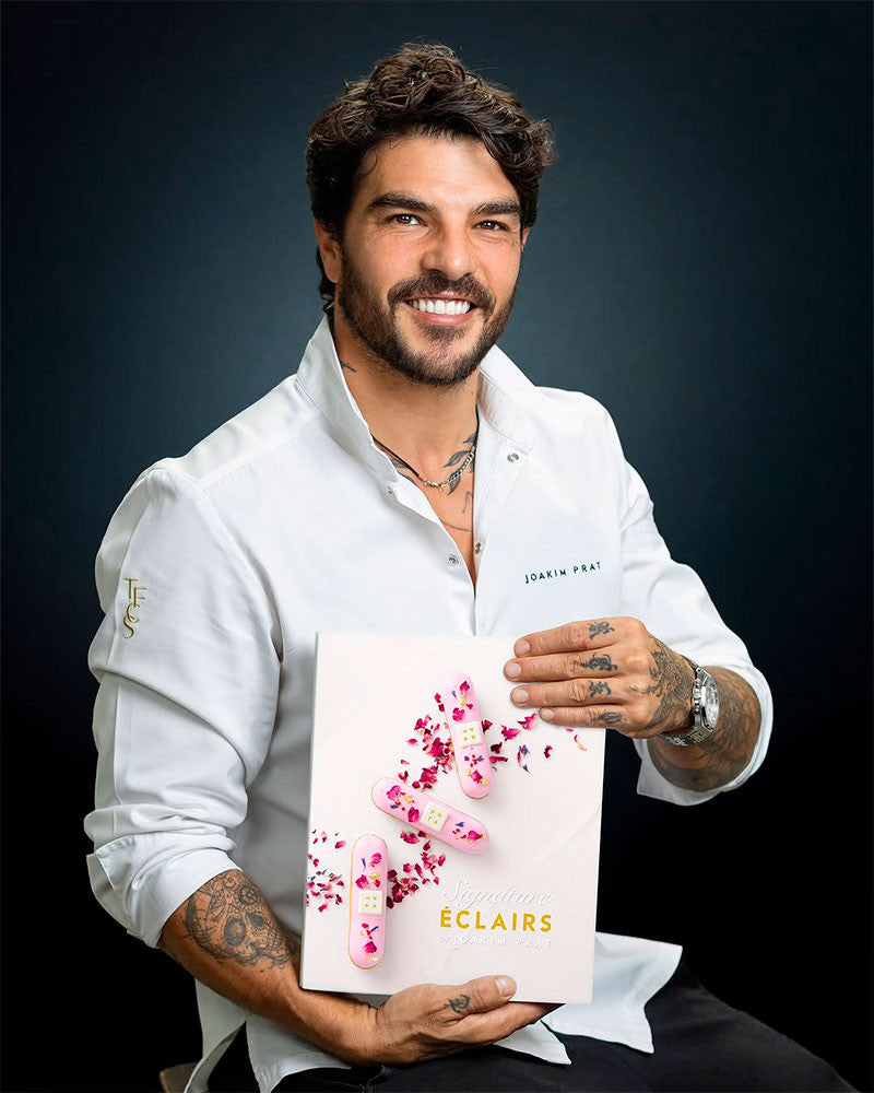 Joakim holding a book titled 'Eclairs' against a dark background