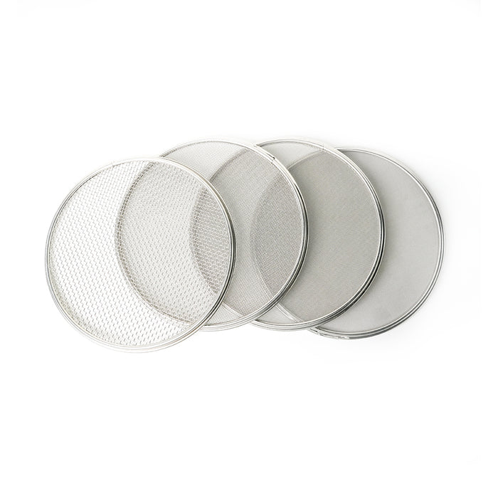 Set of four round metal sieves on a white background