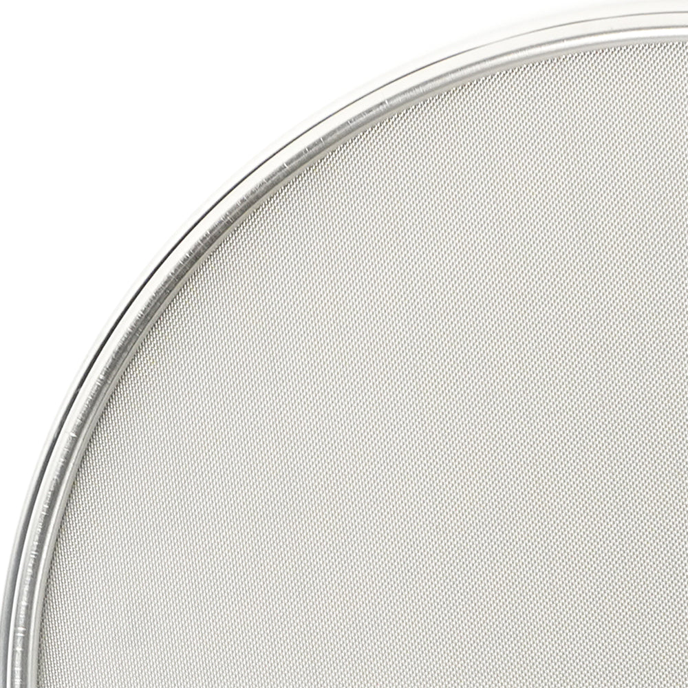Close-up of a round metal mesh filter on a white background