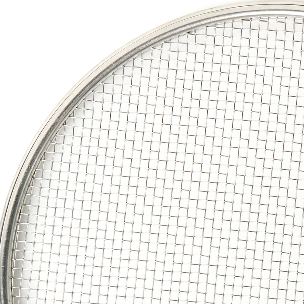 Close-up of a metal mesh filter with a white background