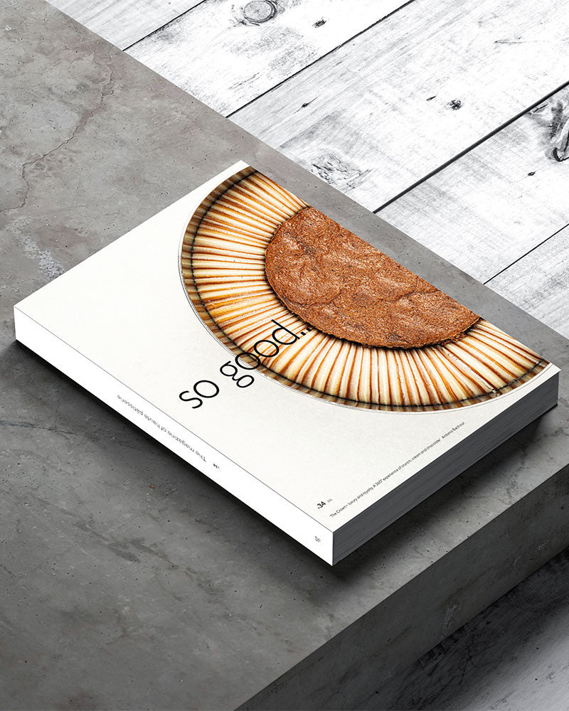 Pastry on the book front labeled 'so good' on a gray surface