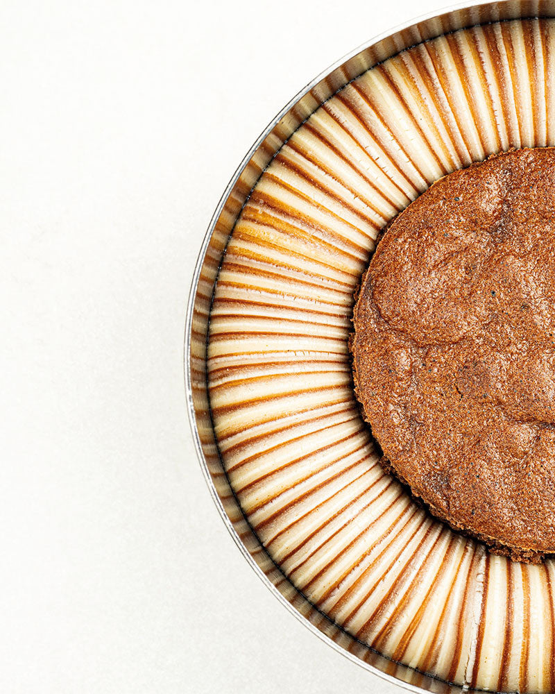 Close-up of a chocolate cookie with a decorative plate on a white background