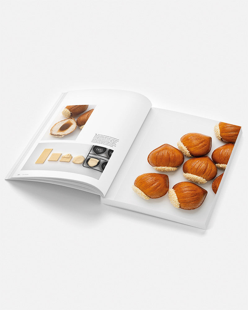Open book showing a page with images of mini cakes and text on a white background