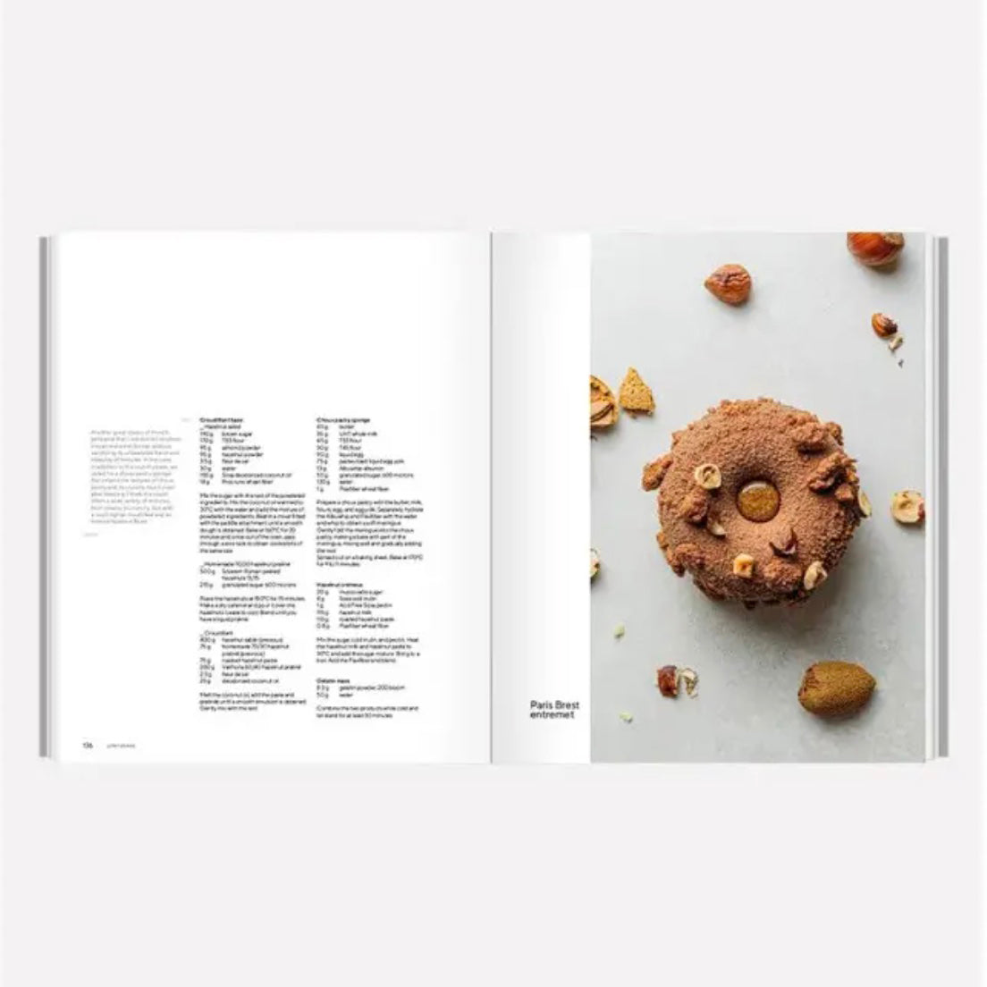 Open book showing a recipe on the left and a picture of a cookie with nuts on the right.