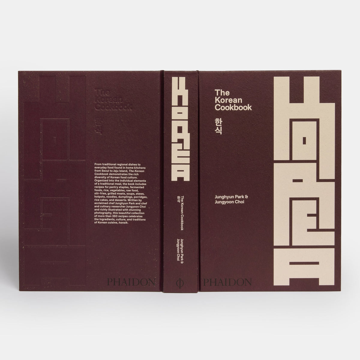 The Korean Cookbook by Phaidon, featuring a deep burgundy cover with large beige geometric Korean characters and white text, shown in a front-and-spine view on a light gray background.