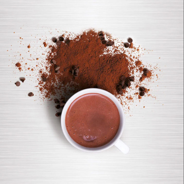 Cup of hot chocolate with hot chocolate mix and chocolate chips on a white background