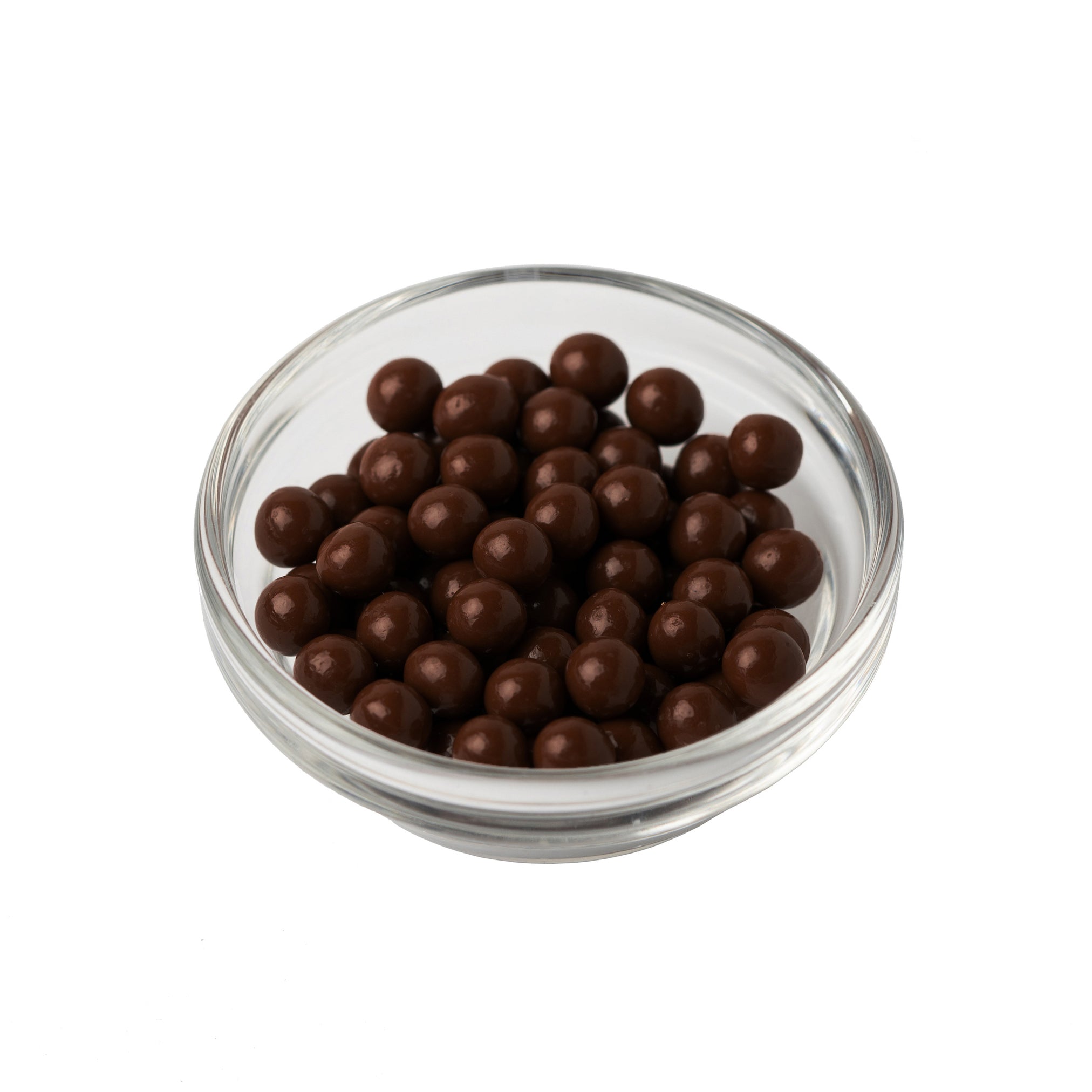 Glass bowl filled with chocolate-covered pearls on a white background