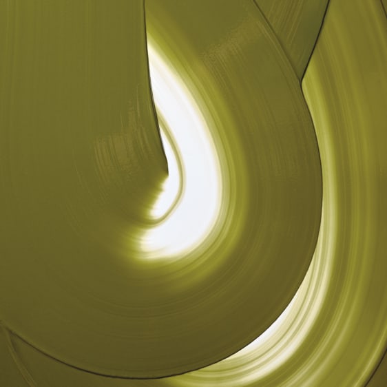 An abstract close-up of a curved, glossy olive-green Valrhona Matcha Inspiration chocolate couverture with a bright white highlight and soft yellow-green shading, resembling a sculptural material or abstract art print.