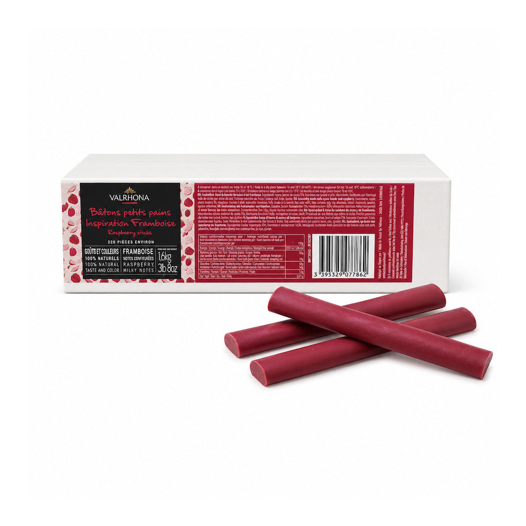 A box of Valrhona Raspberry Inspiration Chocolate Batons, with three dark red wax sticks displayed in front on a clean white background.
