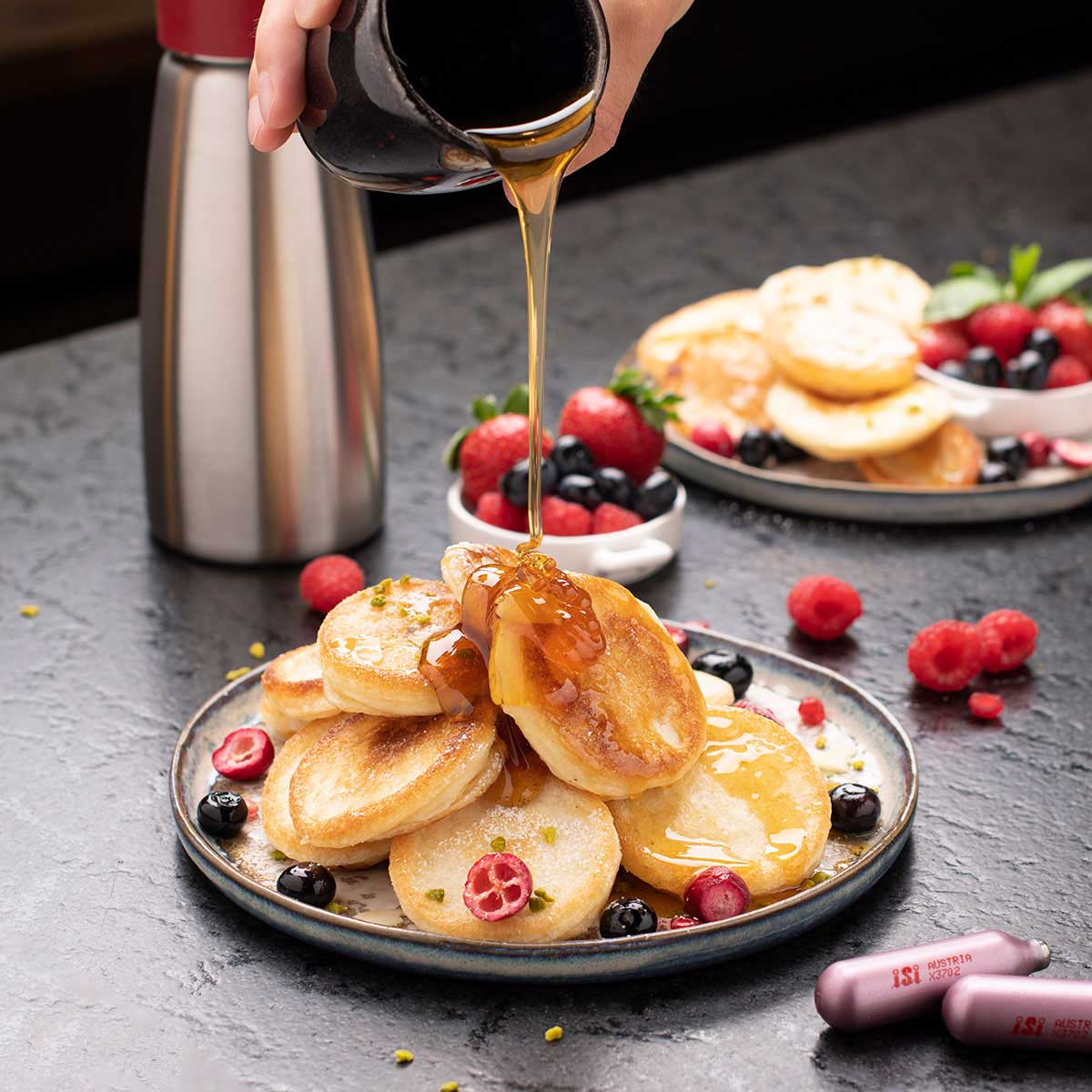 Sauces made from iSi 1L Whipping Siphon on a plate of pancakes
